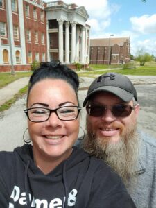 Jackie & Bob standing in front of Griffin Memorial Hospital, an abandoned inane asylum in Oklahoma on one of our adventures